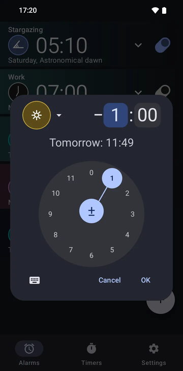 Risetime's create-alarm dialog open over the alarm list: the sun-shaped Noon anchor icon, an offset of minus 1 hour and 00 minutes with the hours field selected, and the line Tomorrow: 11:49. A circular hours dial with 1 selected fills the lower half, with Cancel and OK beneath it.
