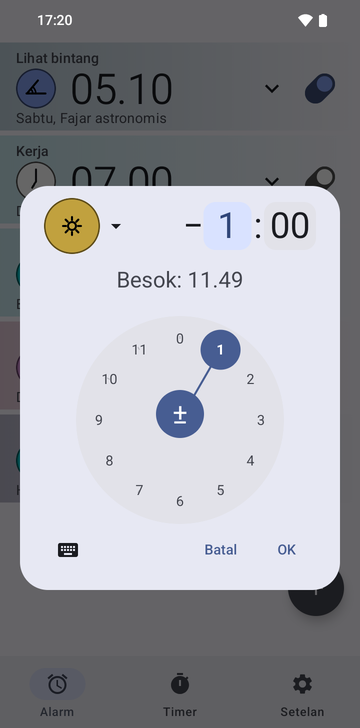 Dialog buat alarm Risetime terbuka di atas daftar alarm: ikon jangkar Noon berwarna emas, selisih minus 1 hour dan 00 minutes dengan kolom jam terpilih, dan baris Tomorrow: 11:49. Dial jam melingkar dengan 1 terpilih memenuhi separuh bawah, dengan tombol papan ketik, Cancel, dan OK di bawahnya.