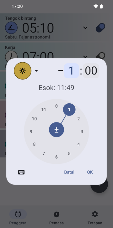 Dialog cipta penggera Risetime terbuka di atas senarai penggera: ikon sauh Noon berwarna emas, anjakan minus 1 hour dan 00 minutes dengan medan jam dipilih, dan baris Tomorrow: 11:49. Dail jam bulat dengan 1 dipilih memenuhi separuh bawah, dengan butang papan kekunci, Cancel dan OK di bawahnya.
